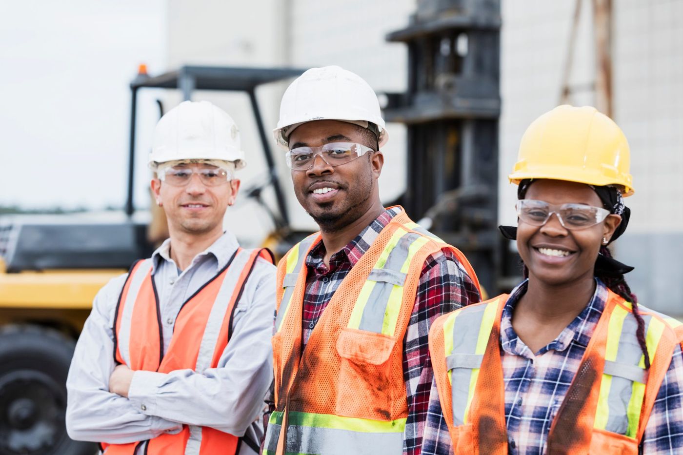 Workers in hard hats and safety vests on site